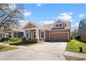 Charming single-Gathering home featuring a well-manicured lawn and a convenient two-car garage at 14720 Sweet Acacia Dr, Orlando, FL 32828