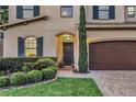 Inviting front entrance with brick path, manicured landscaping, and a view of interior window at 1558 Terra Verde Way, Ocoee, FL 34761