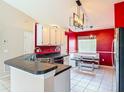 Eat-in kitchen with tile floors and a built-in dining nook and modern lighting at 1606 Bismarck Dr, Deltona, FL 32725