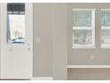 Bright entryway with a front door, showing the interior wall and large windows at 16217 Prairie School Dr, Winter Garden, FL 34787