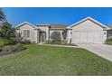 Charming single-story home with well-manicured lawn and stucco facade at 1900 Nw 57Th Ct, Ocala, FL 34482