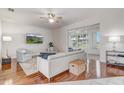 Bright living room boasts hardwood floors, ceiling fan, and sliding glass doors to the lanai at 1900 Nw 57Th Ct, Ocala, FL 34482