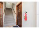 Interior stairwell with neutral carpet, wood trim, and a visible apartment door with hardware at 200 Maitland Ave # 52, Altamonte Springs, FL 32701