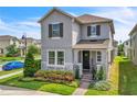 Charming two-story home with stone accents, manicured landscaping, and welcoming front entrance at 203 Wise Owl Way, Winter Springs, FL 32708
