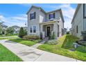 Inviting two-story home with stone accents, well-maintained lawn, and welcoming walkway at 203 Wise Owl Way, Winter Springs, FL 32708