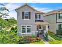 Beautiful two-story home with stone accents, lush landscaping, and a cozy front porch at 203 Wise Owl Way, Winter Springs, FL 32708