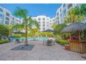 Resort-style pool area with palm trees, lounge chairs, and a tiki bar at 204 E South St # 2061, Orlando, FL 32801