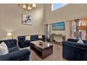 Sunlit living room showcasing comfortable seating, media console, and large windows at 213 Hideaway Beach Ln, Kissimmee, FL 34746