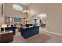 Open-concept living room featuring plush seating, media console, and seamless access to dining area at 213 Hideaway Beach Ln, Kissimmee, FL 34746