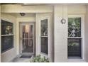 Inviting front entry with textured walls, decorative glass windows, and a secure storm door for added protection at 239 Hill St # 239, Casselberry, FL 32707