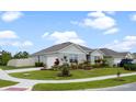 Well-manicured lawn, driveway, and landscaping of this single-story home at 2900 Sunridge Loop, St Cloud, FL 34771