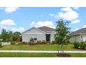 Well-maintained single-story home with green lawn and landscaped front yard, offering great curb appeal at 2900 Sunridge Loop, St Cloud, FL 34771