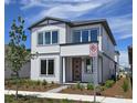 Charming two-story home featuring a modern design, beautiful landscaping, and a welcoming red door at 2980 Embark Trail, St Cloud, FL 34771