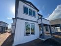 Modern two-story home with gray trim, large windows, and covered front porch, ready for personalization at 2980 Embark Trail, St Cloud, FL 34771