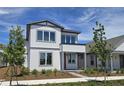 Charming two-story home featuring a modern design, beautiful landscaping, and a welcoming red door at 2980 Embark Trail, St Cloud, FL 34771