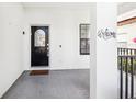 Welcoming entryway with decorative glass front door, sidelight and a 'Welcome' wall hanging at 332 Summer Place Loop, Clermont, FL 34714