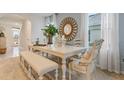 Bright dining room featuring a large table, bench seating, and elegant decor at 3471 Costello Cir, Winter Haven, FL 33884