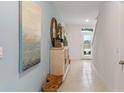 Beautiful light-filled hallway showcasing decor, tile floors and archways at 3475 Costello Cir, Winter Haven, FL 33884
