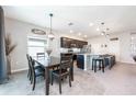 A modern eat-in kitchen and dining area featuring stainless steel appliances and an island with bar seating at 4231 Swan St, Haines City, FL 33844