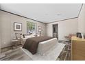 Relaxing main bedroom featuring a large window, complemented by minimalist decor at 4425 Mobilaire Dr, Orlando, FL 32822