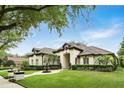 Beautiful single-story home featuring a tile roof, well-kept lawn, mature landscaping, and a serene front fountain at 4517 Old Carriage Trail, Oviedo, FL 32765