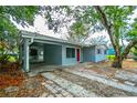 Exterior angle showing covered area, red door and red shutters at 510 Brighton Way, Casselberry, FL 32707