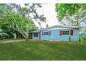 Charming single story home with a lush green lawn and mature landscaping and red shutters at 510 Brighton Way, Casselberry, FL 32707