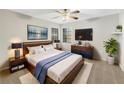 Comfortable bedroom with a large bed, modern decor, and ample natural light at 5212 Waterwood Run, Bartow, FL 33830