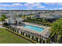 Inviting community pool with a spacious deck, lounge chairs, and a shaded cabana area at 5648 Cedar Chase Dr, St Cloud, FL 34771