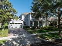Charming two-story home with a brick driveway, manicured lawn, and inviting front porch at 6152 Meriwether, Winter Garden, FL 34787