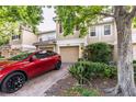 Exterior view of a townhome featuring a garage and well-maintained landscaping at 6874 Sperone St, Orlando, FL 32819