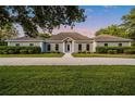 Beautiful single-story home with manicured lawn and symmetrical landscaping along the front walkway at 8368 Rambling River Dr, Sanford, FL 32771