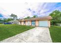 Cozy home with a large driveway and well-manicured lawn at 855 Third St, Orange City, FL 32763