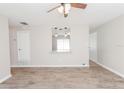 Bright living room with wood-look flooring and a ceiling fan at 855 Third St, Orange City, FL 32763