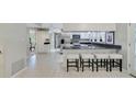 Bright kitchen featuring white cabinets, stainless steel appliances, and a breakfast bar with seating at 981 Victoria Ter, Altamonte Springs, FL 32701