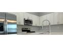 Modern kitchen featuring stainless steel appliances and bright white cabinetry at 16435 Sw 27Th Ave, Ocala, FL 34473