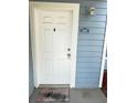 A welcoming front door, freshly painted and accented by a stylish light fixture for added curb appeal at 2608 Grassy Point Dr # 102, Lake Mary, FL 32746