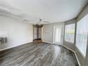 Spacious living room with stylish floors, a ceiling fan, and a glass door that provides ample natural light at 2608 Grassy Point Dr # 102, Lake Mary, FL 32746
