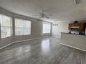 Bright living room featuring durable flooring, abundant natural light and seamlessly flows into the kitchen at 2608 Grassy Point Dr # 102, Lake Mary, FL 32746