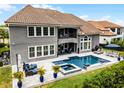 Stunning backyard featuring a pool, spa, patio with outdoor seating and a balcony at 3863 Grassland Loop, Lake Mary, FL 32746