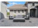 Back patio with outdoor furniture, including a sofa, chairs, and a coffee table, under string lights at 3863 Grassland Loop, Lake Mary, FL 32746