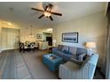 Inviting living room featuring a comfortable sofa, armchair, stylish decor, and a ceiling fan at 8125 Resort Village Dr # 51006, Orlando, FL 32821
