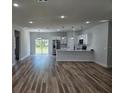 Spacious open-concept home with modern hardwood floors, leading to the kitchen at 16670 Sw 29Th Terrace Rd, Ocala, FL 34473