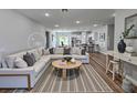 Spacious living room with hardwood floors, an area rug, and a stylish sectional sofa at 16670 Sw 29Th Terrace Rd, Ocala, FL 34473
