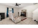 Well-lit living room with tile floors, neutral walls, a TV, and comfortable seating at 542 Patton Loop, Bartow, FL 33830