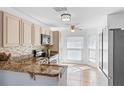 Well-lit kitchen featuring granite countertops, modern appliances, ample cabinet space, and a cozy breakfast nook with abundant natural light at 9301 Echo Run, Orlando, FL 32817