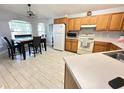 Cozy kitchen with tile flooring, wooden cabinets, and matching dining area with natural light at 1002 Courtland St, Orlando, FL 32804