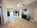 Bright and spacious living room featuring tile flooring, ceiling fans, and sliding glass door to the yard at 1002 Courtland St, Orlando, FL 32804