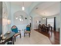 Inviting foyer with tile flooring, elegant furnishings, and seamless transition to the dining area at 16843 Cedar Run Dr, Orlando, FL 32828