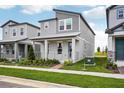 Attractive two-story home featuring modern architectural style, gray siding, and well-maintained lawn at 5127 Passion Flower Way, Winter Garden, FL 34787
